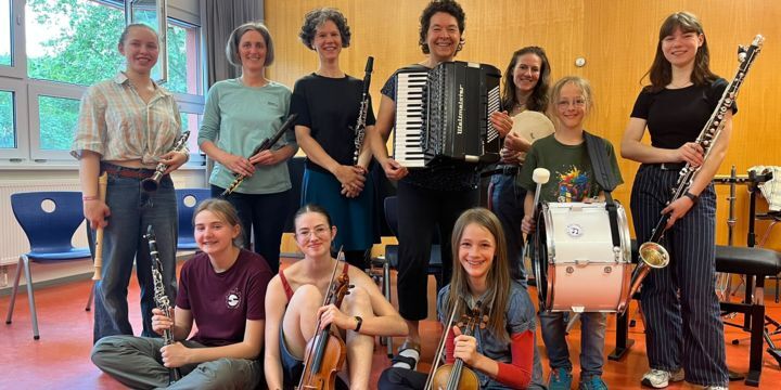 Klezmerensemble_10 Personen unterschiedlichen Alters mit ihren Instrumenten schauen in die Kamera